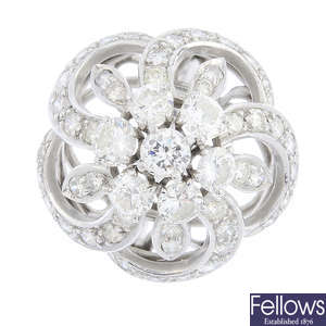 A platinum diamond floral dress ring.