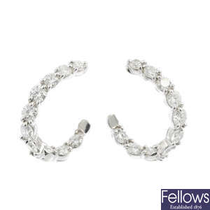 TIFFANY & CO. - a pair of platinum diamond 'Inside-Out Hoop' earrings.