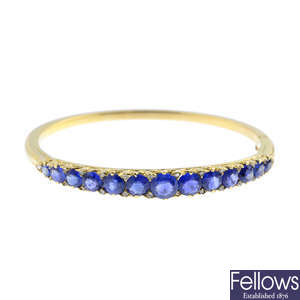 An early 20th century 18ct gold, sapphire and diamond hinged bangle.