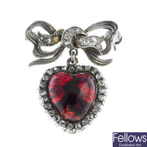 A late Victorian silver and gold garnet and diamond brooch.