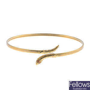 A 9ct gold garnet snake bangle and a gate bracelet.