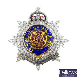 An early 20th century platinum and gold, diamond, ruby and enamel Royal Hampshire regimental brooch.