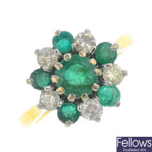An 18ct gold emerald and diamond cluster ring.
