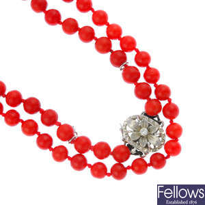 An early 20th century coral bead necklace with diamond clasp.