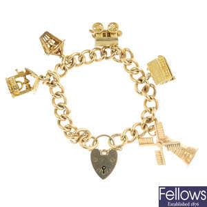 A 1970s 9ct gold charm bracelet with five charms.