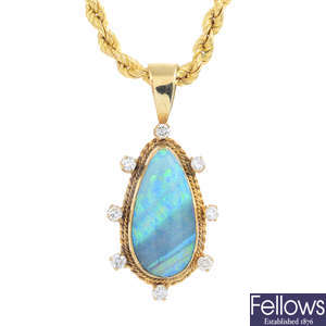 A 9ct gold boulder opal and diamond pendant, with 9ct gold rope-twist chain.