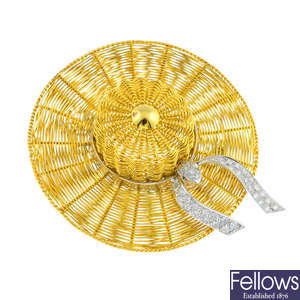 An 18ct gold hat brooch with diamond ribbon.