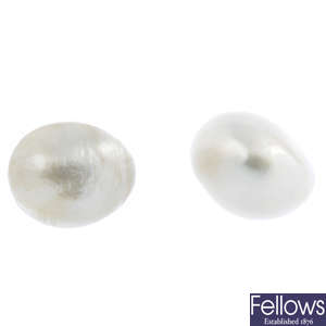 A pair of oval-shape natural pearl stud earrings.