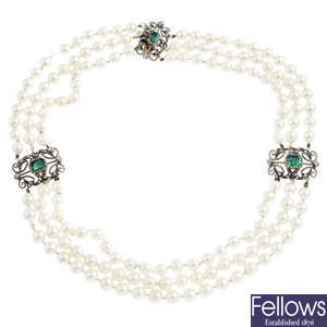 An emerald, diamond and cultured pearl three-row necklace.