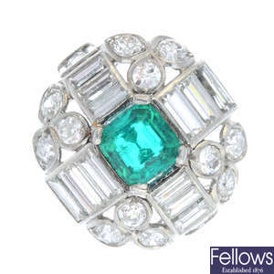 A mid 20th century platinum Colombian emerald and diamond dress ring.