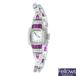 EBEL - a lady's Art Deco platinum, ruby and diamond cocktail watch.