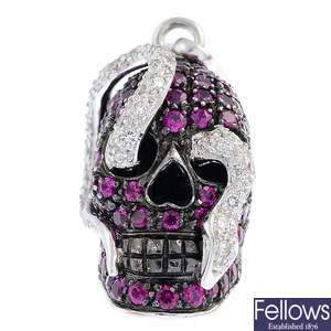 THEO FENNELL - an 18ct gold ruby and diamond 'Skull and Snake' charm.