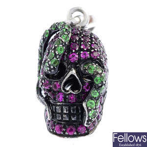 THEO FENNELL - an 18ct gold ruby and tsavorite garnet 'Skull and Snake' charm.