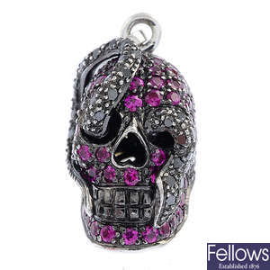 THEO FENNELL - an 18ct gold ruby and 'black' diamond 'Skull and Snake' charm.