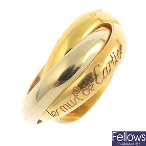 CARTIER - an 18ct gold 'Les Must de Cartier' trinity ring.