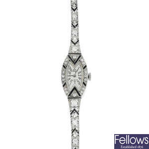 An Art Deco platinum, diamond and onyx watch.