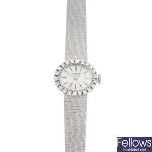 LONGINES - a lady's mid 20th century gold diamond watch.