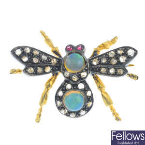A diamond, opal and ruby insect brooch.
