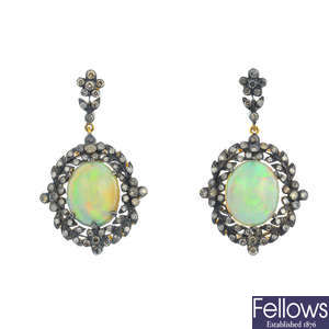 A pair of opal and diamond earrings.