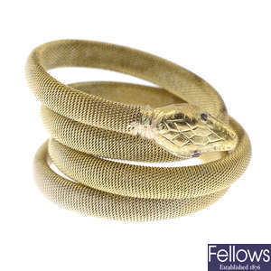 A late 19th century gold garnet flexible snake bangle.