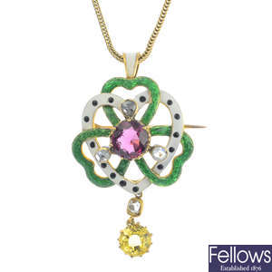 An early 20th century gold garnet, sapphire, diamond and enamel pendant.