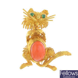 A mid 20th century gold coral and emerald brooch.