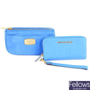 MICHAEL KORS - a blue wallet and matching travel pouch.