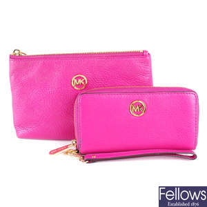 MICHAEL KORS - a pink wallet and matching cosmetics pouch.