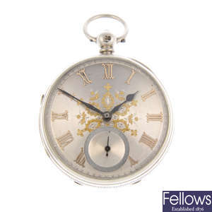A silver open face pocket watch with another silver pocket watch.