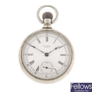A white metal open face pocket watch by Waltham with two pocket watches.