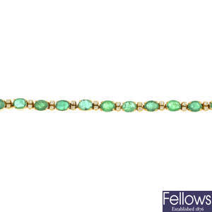 An emerald and diamond line bracelet.
