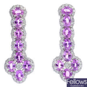 A pair of pink sapphire and diamond earrings.