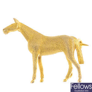 A mid 20th century 9ct gold horse brooch.