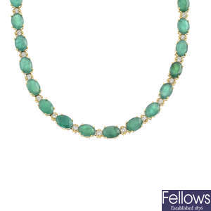 An emerald and diamond necklace.