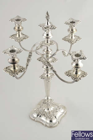 A modern silver four branch candelabrum with filled base.