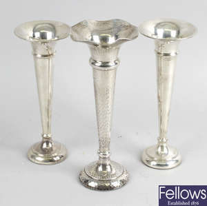 An Edwardian hammered silver bud vase & two later plain examples, all filled bases. 