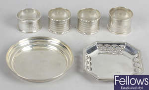 A selection of small silver items to include napkin rings, trinket dishes, miniature trophy & condiments.