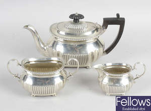 A late Victorian silver three piece bachelor tea set.