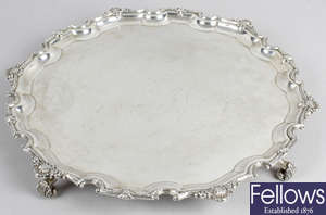 A mid-20th century large silver salver on scroll feet.