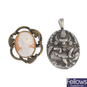 A late Victorian Indian silver locket and a base metal shell cameo brooch.