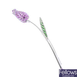 A sapphire and tsavorite garnet floral brooch.