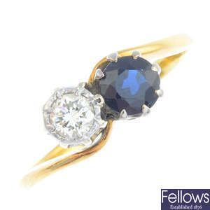 A sapphire and diamond two-stone crossover ring.