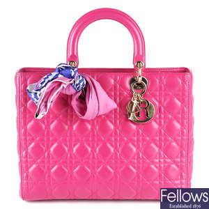 CHRISTIAN DIOR - a fuchsia pink leather Cannage Lady Dior GM handbag.