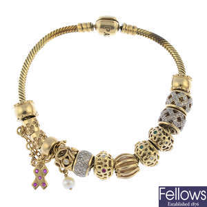 PANDORA - a bracelet, four charms, with seven non-designer charms.