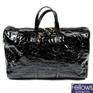 GIANFRANCO FIERRE - a patent leather wheeled travel bag.