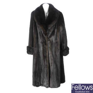 A full-length ranch mink coat with fox fur trim.