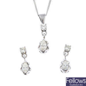 A diamond pendant with an 18ct gold chain and a pair of matching 18ct gold earrings.