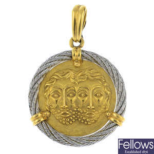 FRED - an 18ct gold and steel 'Force 10' Zodiac pendant.
