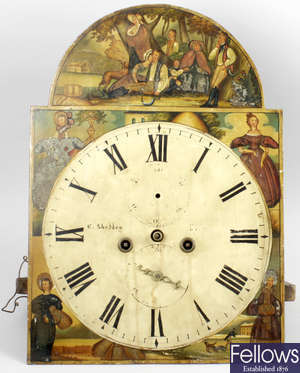 An antique longcase clock dial and mechanism.