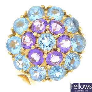 An 18ct gold amethyst and topaz ring.